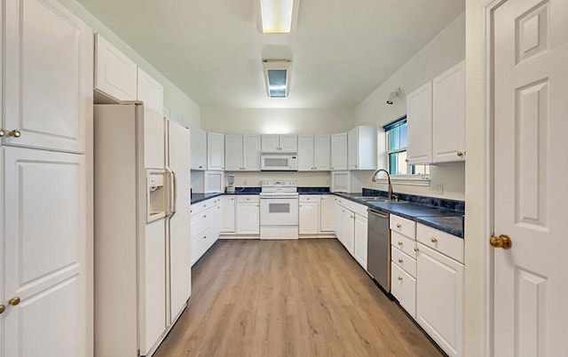 556 Old Speegleville Rd, Woodway, TX 76712 - kitchen featuring white appliances, a sink, light wood finished floors, and white cabinetry