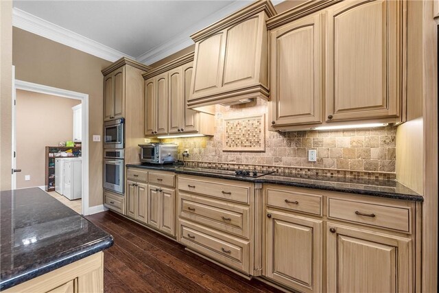 kitchen with dark wood-type flooring, dark stone countertops, black electric cooktop, and a toaster