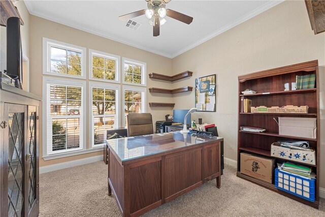 office area featuring crown molding, baseboards, light colored carpet, visible vents, and ceiling fan