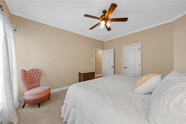 bedroom featuring baseboards, carpet floors, a ceiling fan, and crown molding