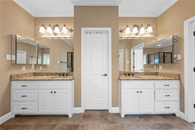 bathroom with baseboards, crown molding, a sink, and two vanities