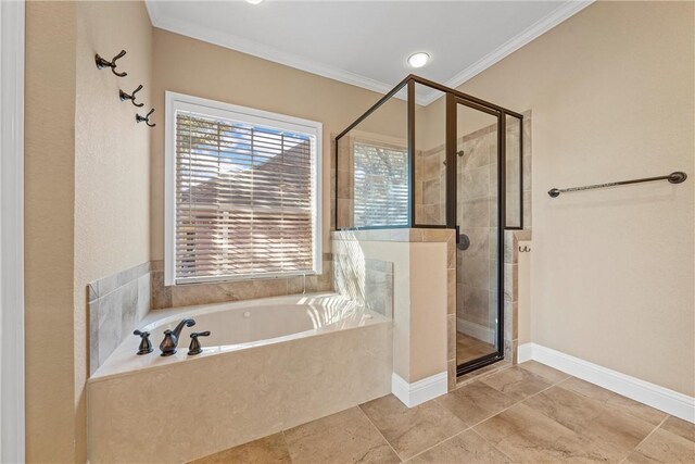 full bath featuring baseboards, crown molding, a garden tub, and a shower stall
