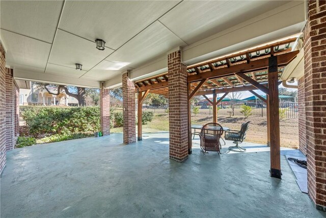 view of patio featuring fence