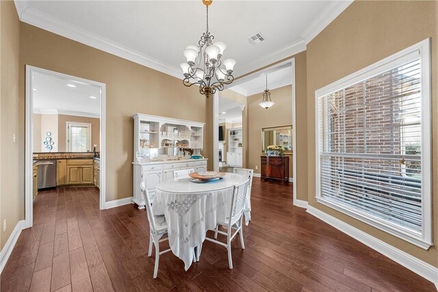 dining room with dark wood-style flooring, ornamental molding, baseboards, and a chandelier