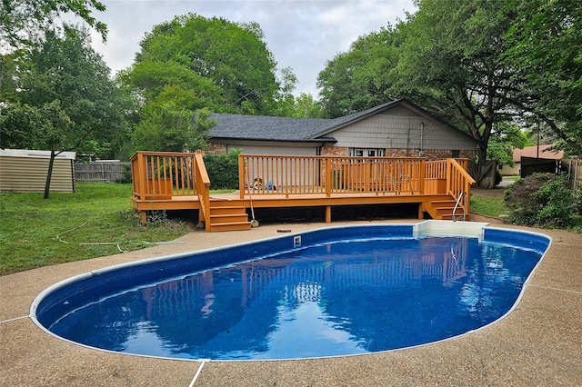 view of pool featuring a fenced in pool, fence, a yard, and a deck