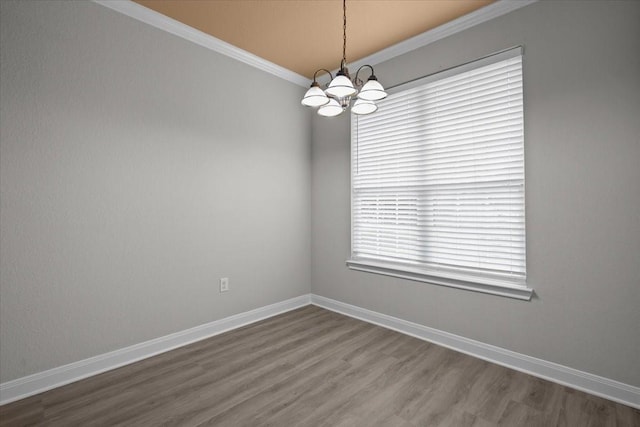 187 Ashland Dr, Woodway, TX 76712 - spare room featuring baseboards, ornamental molding, wood finished floors, and a notable chandelier