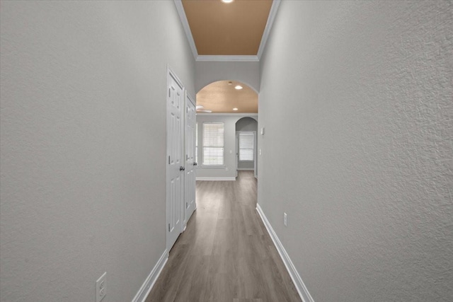 187 Ashland Dr, Woodway, TX 76712 - hallway featuring crown molding, arched walkways, wood finished floors, baseboards, and a textured wall