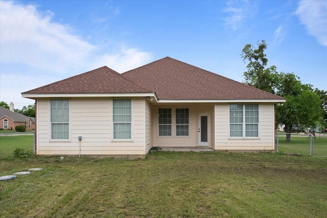 187 Ashland Dr, Woodway, TX 76712 - rear view of house with fence, a shingled roof, and a lawn