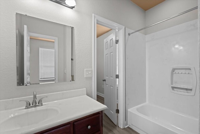 187 Ashland Dr, Woodway, TX 76712 - bathroom featuring shower / tub combination, wood finished floors, and vanity