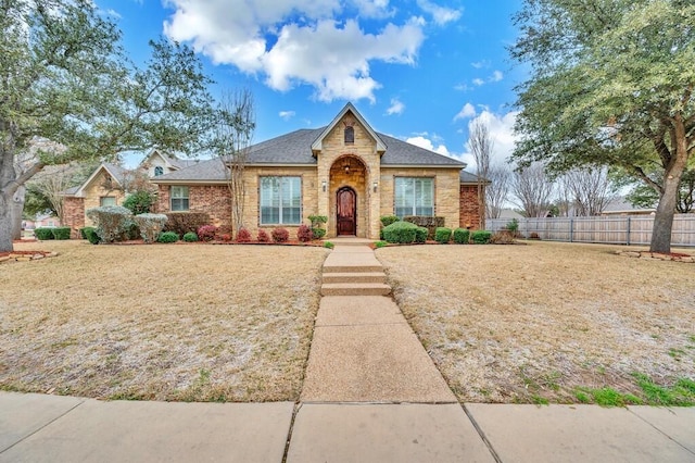 304 Chamberly Rd, Waco, TX 76712 - view of front of house featuring brick siding, a shingled roof, a front lawn, and fence