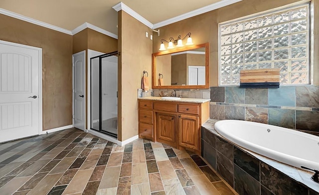 304 Chamberly Rd, Waco, TX 76712 - full bathroom featuring vanity, ornamental molding, a garden tub, and a stall shower
