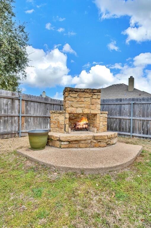 304 Chamberly Rd, Waco, TX 76712 - view of yard featuring an outdoor stone fireplace and a fenced backyard