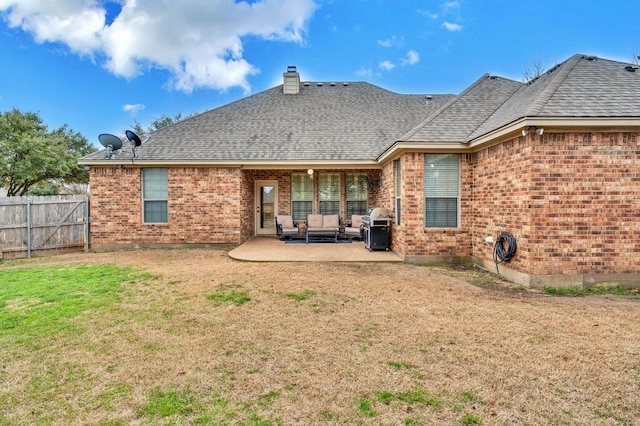 304 Chamberly Rd, Waco, TX 76712 - back of property featuring fence, brick siding, an outdoor living space, a patio area, and a yard