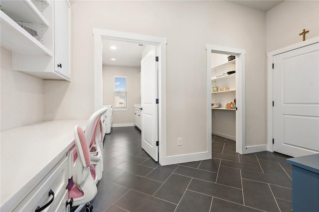 laundry room with recessed lighting, baseboards, and dark tile patterned flooring