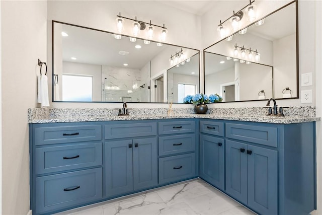 bathroom featuring a marble finish shower, double vanity, marble finish floor, and a sink