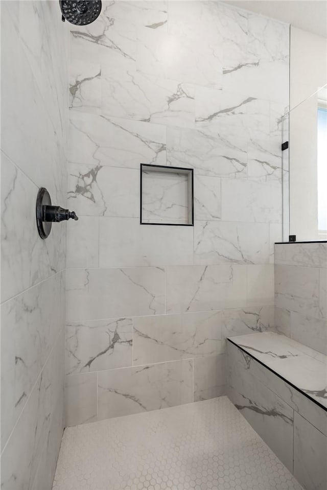 full bath with tiled shower