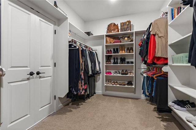 walk in closet with carpet
