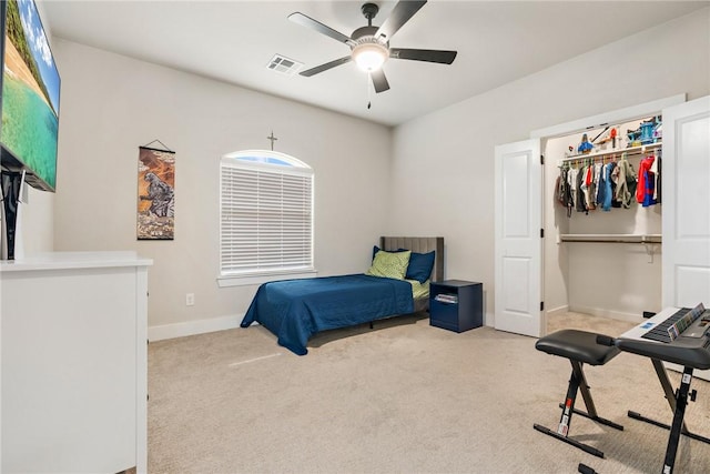 carpeted bedroom featuring ceiling fan, baseboards, visible vents, and a closet
