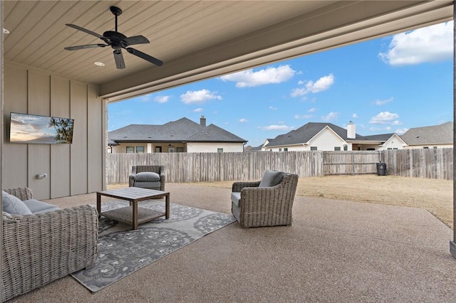 view of patio / terrace with a fenced backyard, a ceiling fan, and a residential view