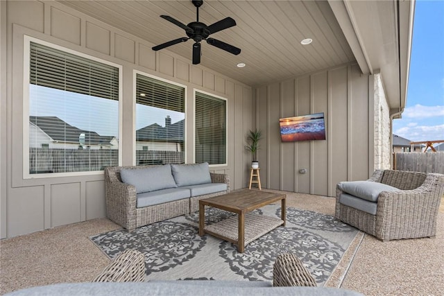 view of patio / terrace with ceiling fan, fence, and an outdoor living space
