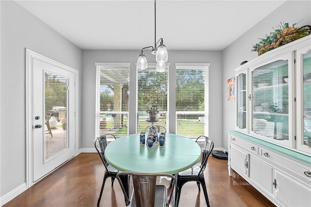 sunroom featuring a chandelier