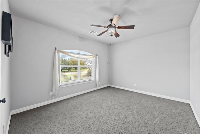 carpeted empty room with visible vents, baseboards, and ceiling fan