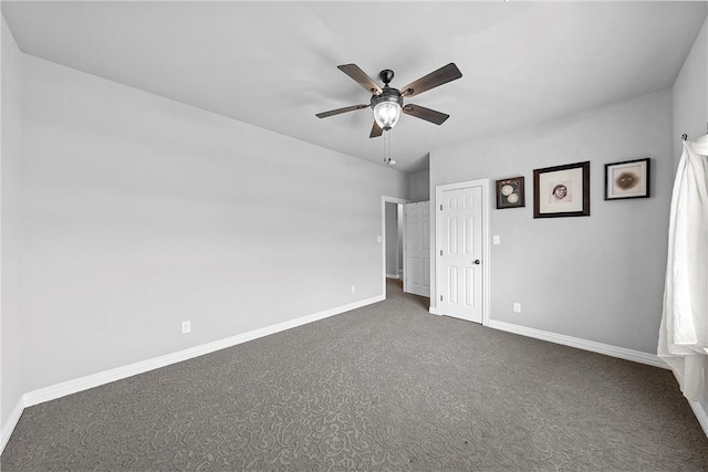 unfurnished room with a ceiling fan, carpet, and baseboards