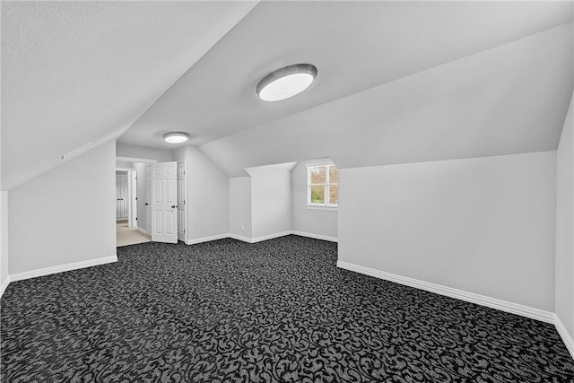bonus room with baseboards and carpet floors