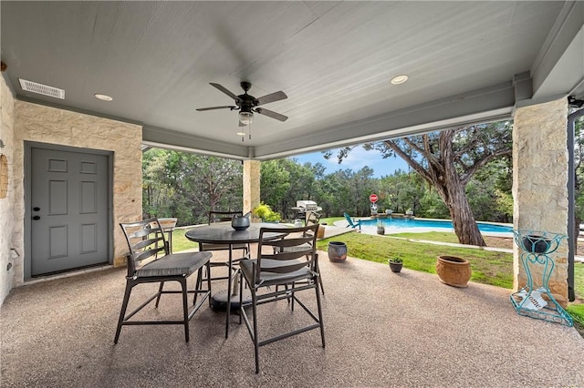 view of patio / terrace featuring an outdoor pool, visible vents, outdoor dining area, and ceiling fan