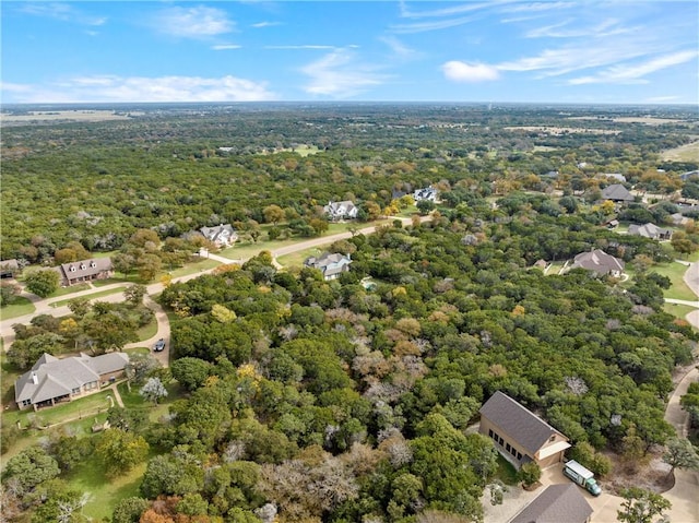 drone / aerial view featuring a wooded view
