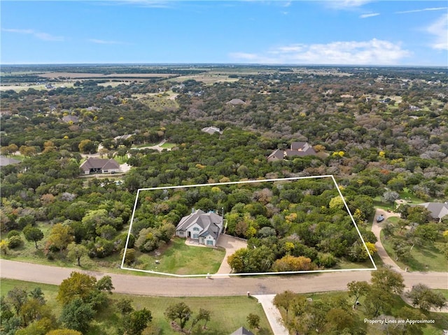 birds eye view of property featuring a wooded view