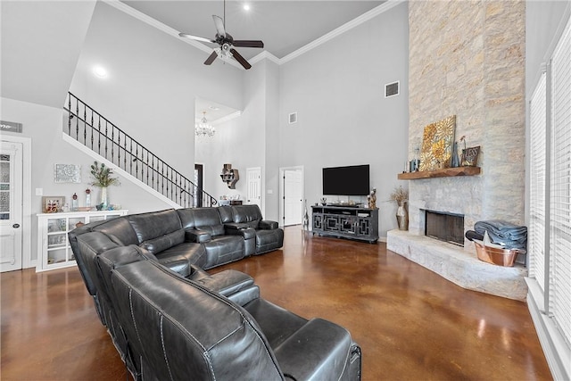 living area featuring visible vents, stairway, concrete flooring, ceiling fan with notable chandelier, and a fireplace