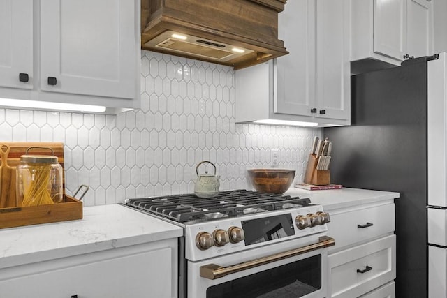 1215 Ropers Alley Rd, Belton, TX 76513 - kitchen featuring tasteful backsplash, white cabinetry, premium range hood, and gas range oven