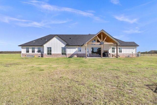 1215 Ropers Alley Rd, Belton, TX 76513 - rear view of property with a yard, brick siding, board and batten siding, and roof with shingles