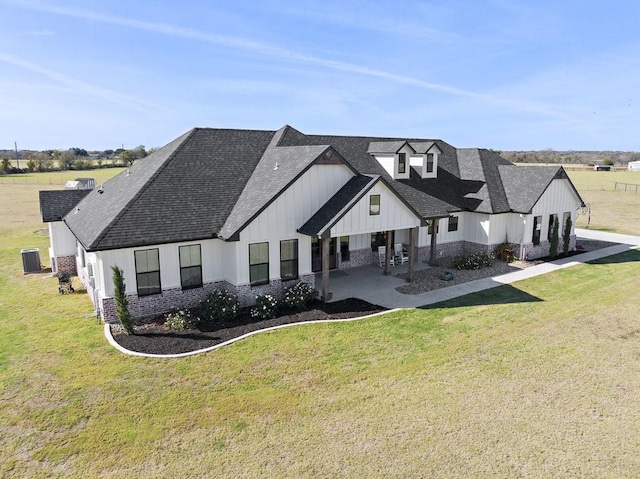 1215 Ropers Alley Rd, Belton, TX 76513 - rear view of property featuring a lawn, board and batten siding, and roof with shingles