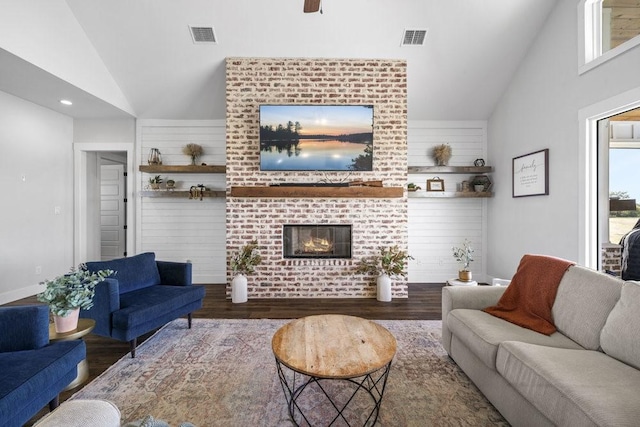1215 Ropers Alley Rd, Belton, TX 76513 - living area with visible vents, a brick fireplace, high vaulted ceiling, and wood finished floors