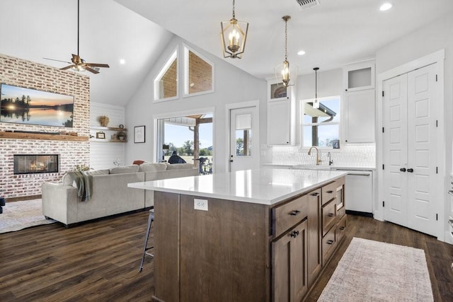 1215 Ropers Alley Rd, Belton, TX 76513 - kitchen with dark wood finished floors, open floor plan, white cabinets, a ceiling fan, and a sink