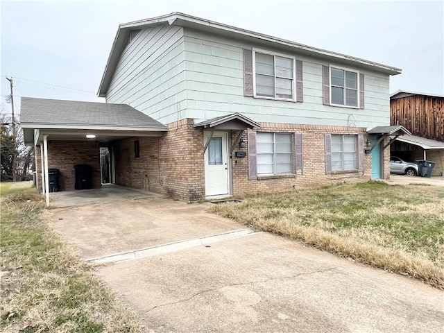 5505 Tennyson Dr, Waco, TX 76710 - view of front facade with brick siding, a front lawn, a carport, and driveway