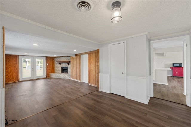 3166 Tokio Rd, West, TX 76691 - unfurnished living room with visible vents, dark wood-type flooring, ornamental molding, and a textured ceiling