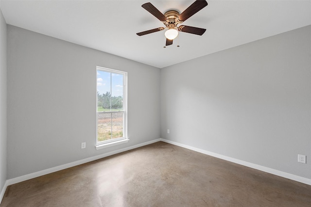 empty room featuring baseboards, a ceiling fan, and concrete floors