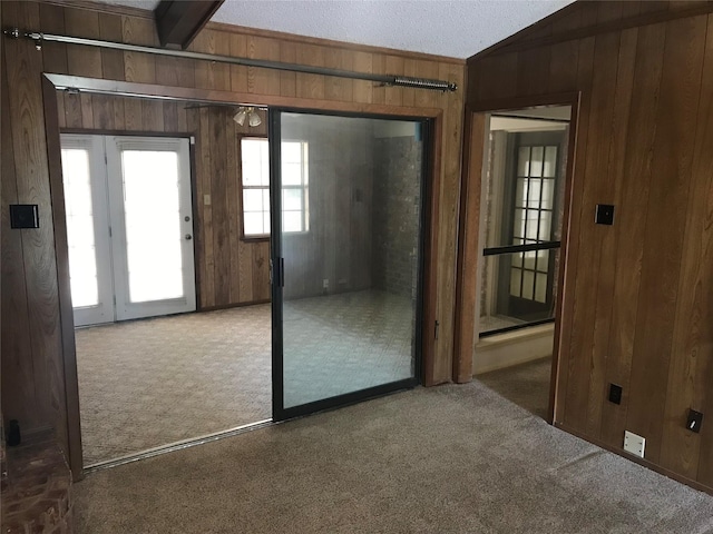 104 Virginia Dr, Hewitt, TX 76643 - doorway to outside with carpet flooring, wooden walls, and lofted ceiling