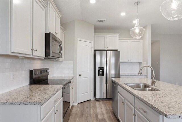 kitchen featuring visible vents, white cabinets, appliances with stainless steel finishes, and a sink