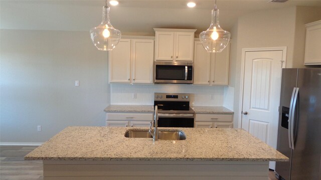 kitchen featuring a sink, decorative backsplash, white cabinets, and appliances with stainless steel finishes