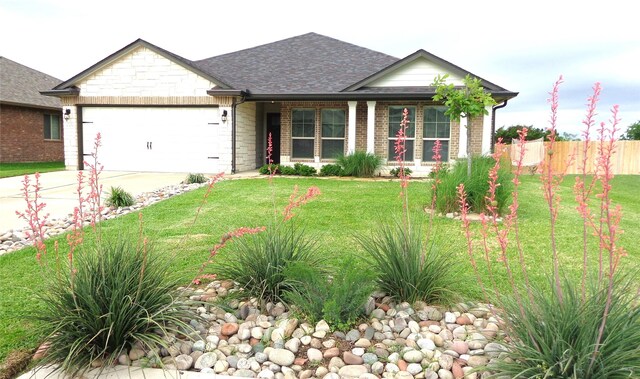 view of front facade with an attached garage, fence, driveway, a front yard, and roof with shingles