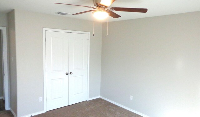 unfurnished bedroom with carpet flooring, a ceiling fan, a closet, visible vents, and baseboards