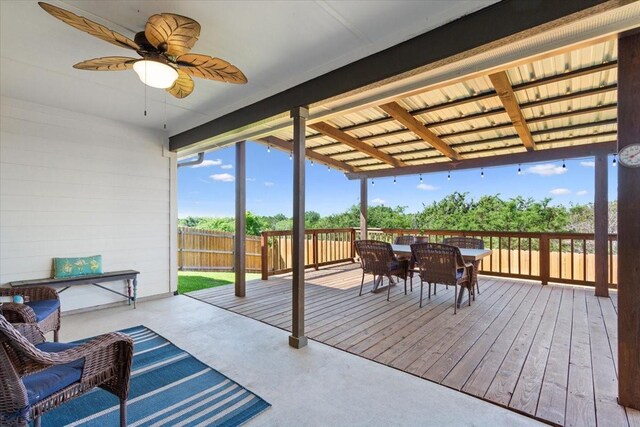 wooden terrace featuring outdoor dining area, fence, and a ceiling fan