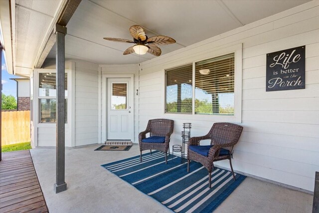 view of patio with ceiling fan and fence