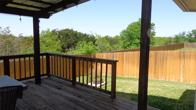 deck featuring a lawn and fence