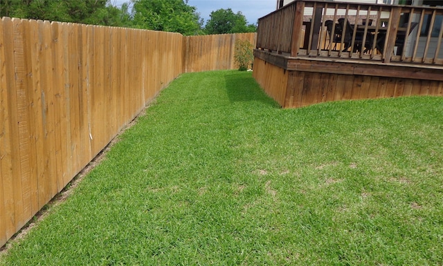 view of yard featuring a fenced backyard and a deck