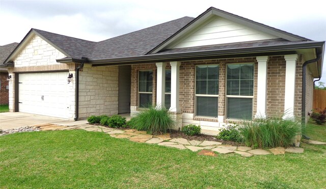 ranch-style home featuring an attached garage, brick siding, roof with shingles, and a front yard